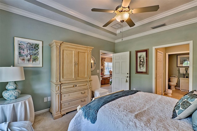 bedroom featuring light carpet, baseboards, visible vents, a raised ceiling, and ornamental molding