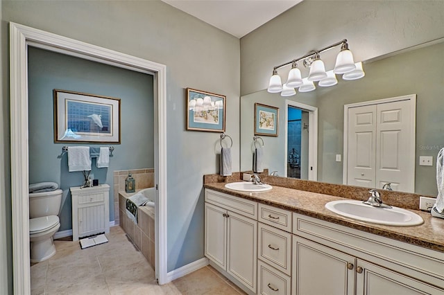 full bathroom featuring toilet, a bath, a sink, and tile patterned floors