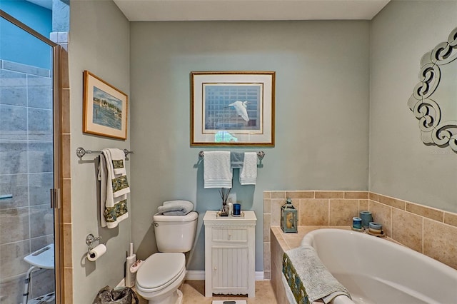 bathroom featuring a bath, a stall shower, toilet, and baseboards