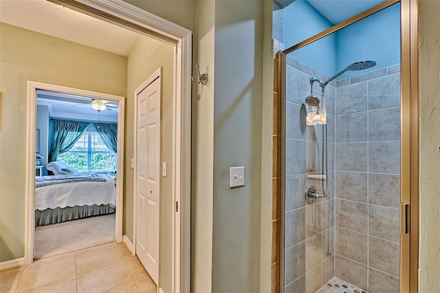 ensuite bathroom featuring ensuite bathroom, a stall shower, ceiling fan, baseboards, and tile patterned floors