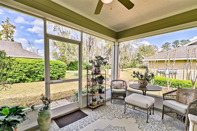 unfurnished sunroom featuring a healthy amount of sunlight and a ceiling fan