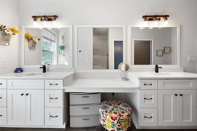 full bathroom featuring two vanities and a sink