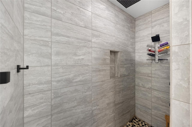 full bath with a tile shower