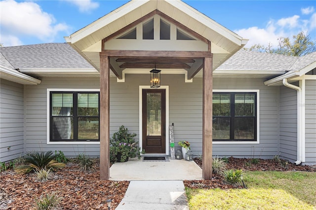 entrance to property with a shingled roof