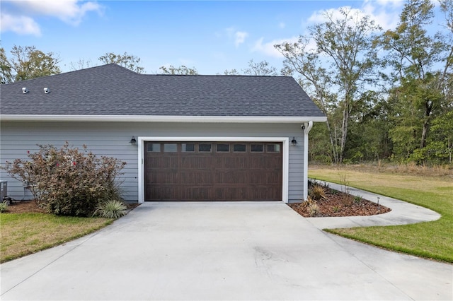 garage featuring concrete driveway