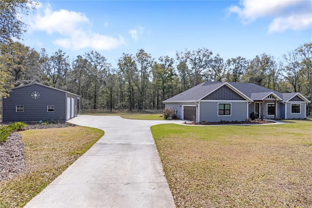 view of front facade featuring a garage, driveway, a front lawn, and board and batten siding