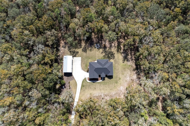 drone / aerial view with a wooded view