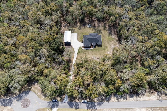 bird's eye view with a wooded view