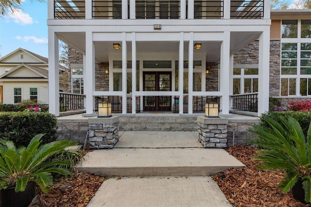 entrance to property with stone siding and covered porch