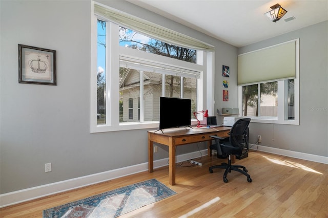 home office featuring baseboards and wood finished floors