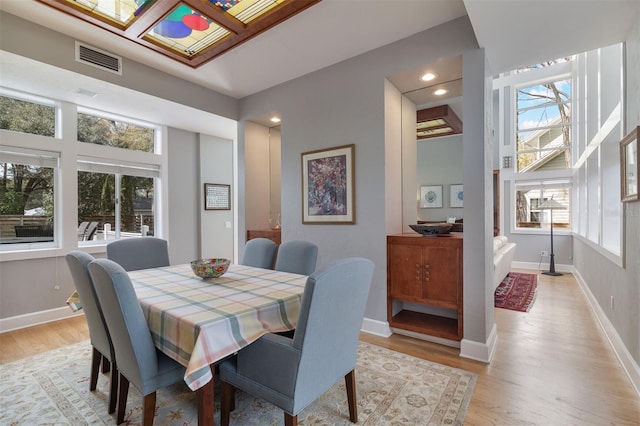 dining space with light wood-style flooring, visible vents, baseboards, and recessed lighting