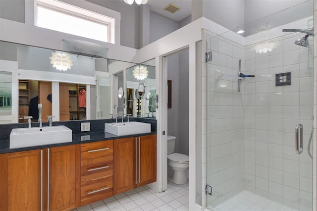 bathroom featuring a shower stall, visible vents, and a sink