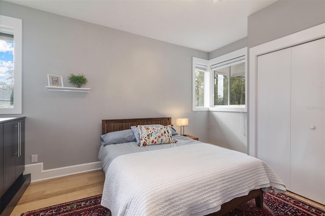 bedroom with baseboards and wood finished floors