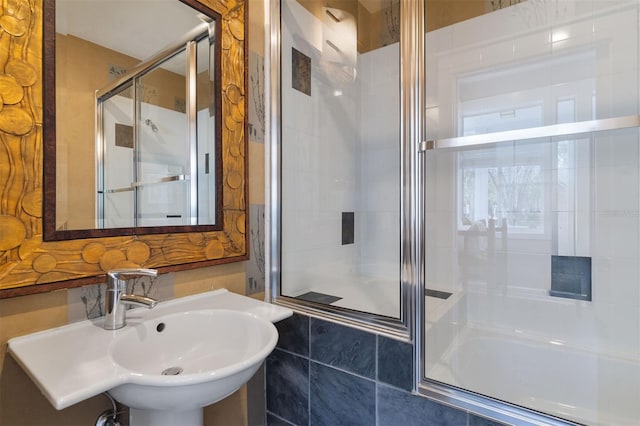 bathroom with a sink and a shower stall