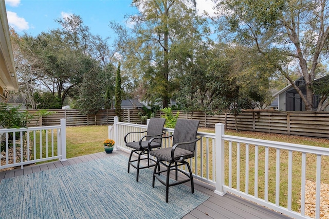 deck featuring a lawn and fence