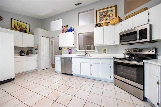 kitchen with visible vents, light countertops, white cabinets, stainless steel appliances, and a sink