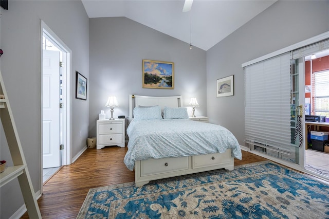 bedroom with ceiling fan, baseboards, wood finished floors, and vaulted ceiling