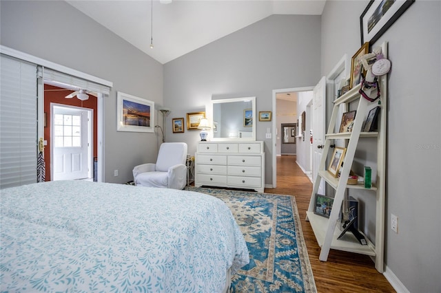 bedroom featuring high vaulted ceiling, baseboards, and wood finished floors