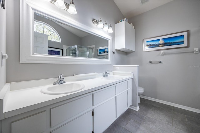 full bathroom with double vanity, baseboards, a stall shower, and a sink