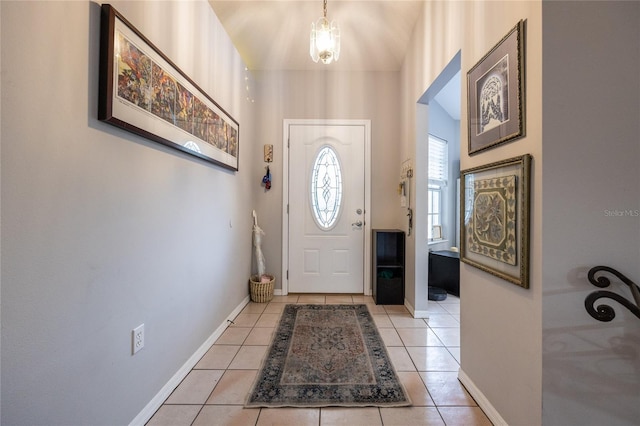 foyer featuring baseboards and light tile patterned flooring