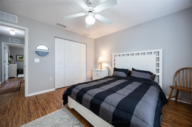 bedroom with visible vents, baseboards, a closet, and wood finished floors