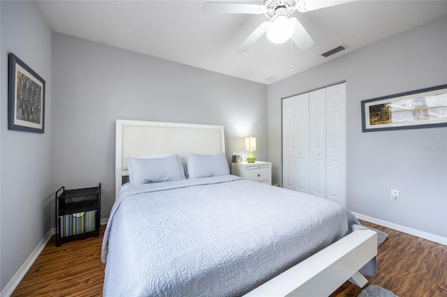 bedroom featuring wood finished floors, visible vents, a closet, and baseboards