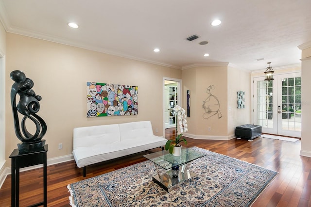 living area with wood finished floors, visible vents, baseboards, french doors, and crown molding