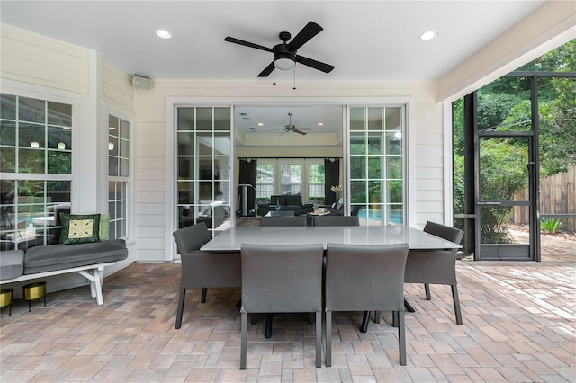 view of patio / terrace with a lanai, ceiling fan, and outdoor dining area