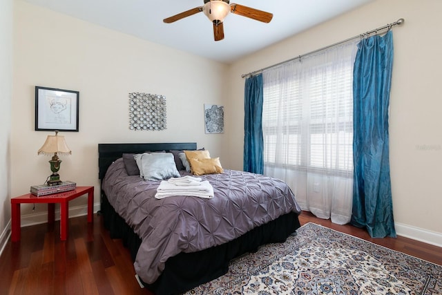 bedroom with wood finished floors, a ceiling fan, and baseboards