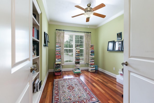 office area featuring baseboards, wood finished floors, and crown molding