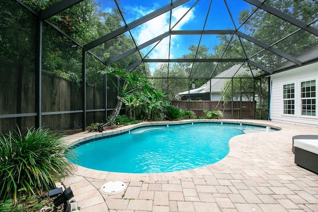 view of pool with a lanai, a patio area, a fenced backyard, and a fenced in pool