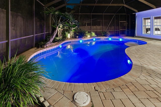 view of swimming pool featuring a patio area, a lanai, a fenced in pool, and fence