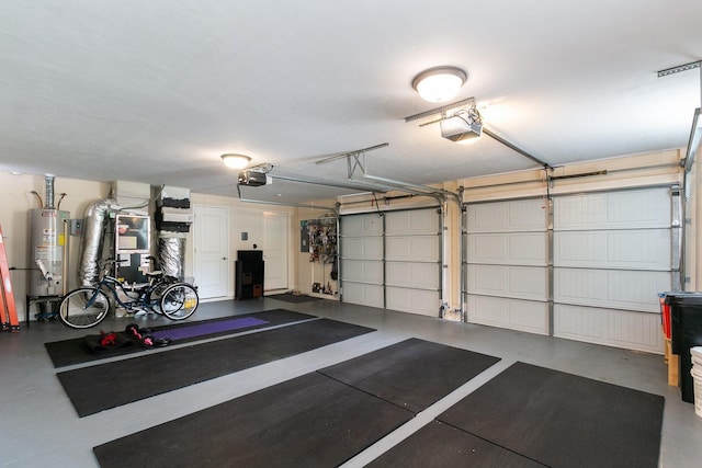 garage with gas water heater and a garage door opener