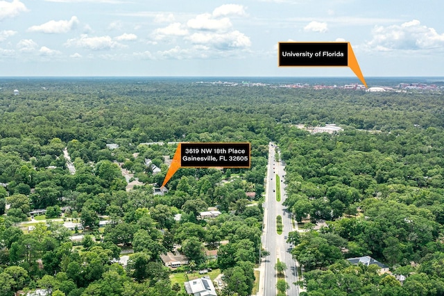 aerial view featuring a wooded view