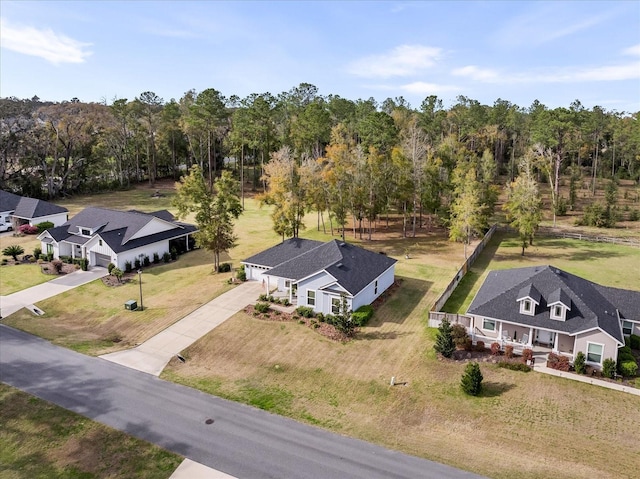 birds eye view of property with a view of trees