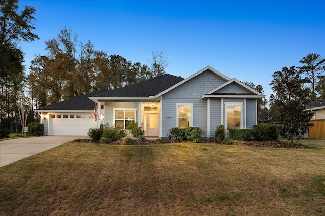 view of front of home featuring a front lawn, concrete driveway, and an attached garage