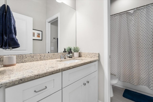 full bath featuring vanity and toilet