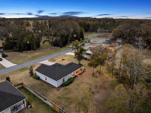 birds eye view of property featuring a forest view