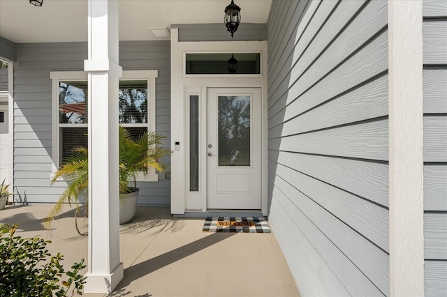 view of exterior entry with covered porch