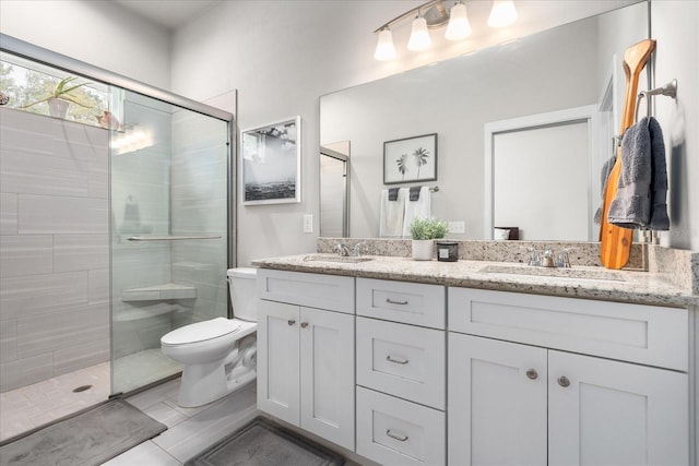 full bath with double vanity, a sink, a stall shower, and toilet