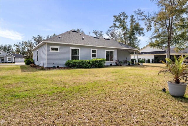 rear view of property featuring a yard