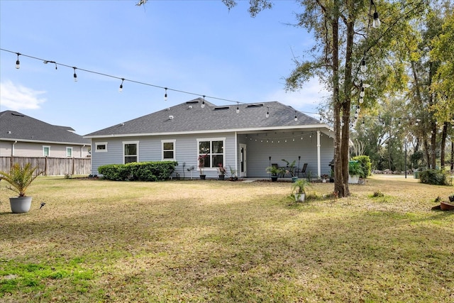 rear view of property with a yard, fence, and a patio area