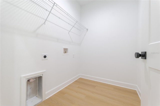 laundry room featuring laundry area, baseboards, light wood-style flooring, washer hookup, and electric dryer hookup