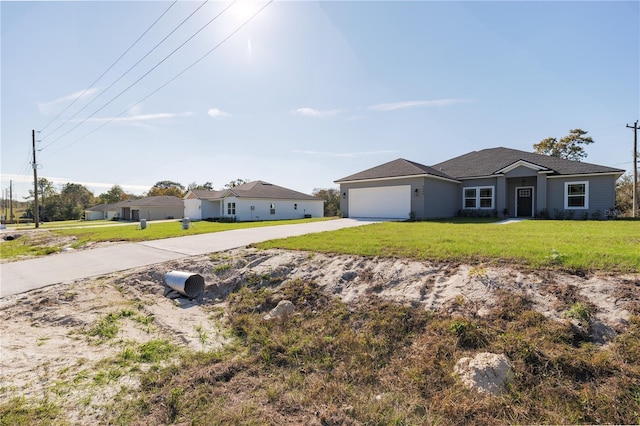 ranch-style house featuring an attached garage, driveway, and a front lawn