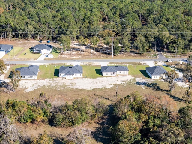 birds eye view of property with a wooded view