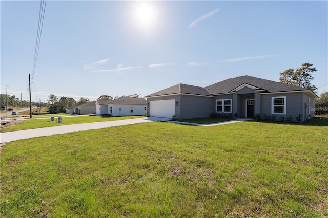 ranch-style house featuring a front yard, driveway, and an attached garage