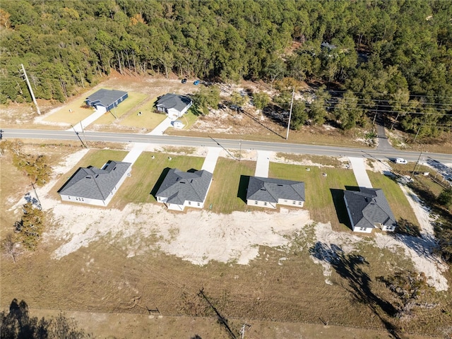 birds eye view of property with a forest view