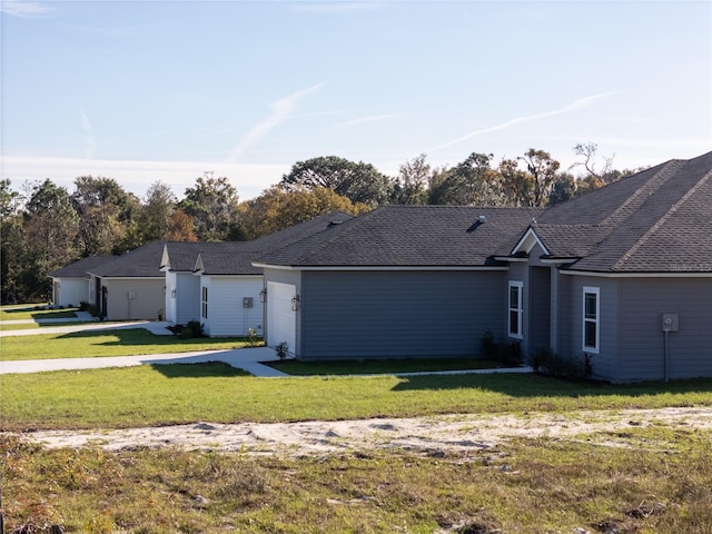 single story home featuring a garage and a front lawn