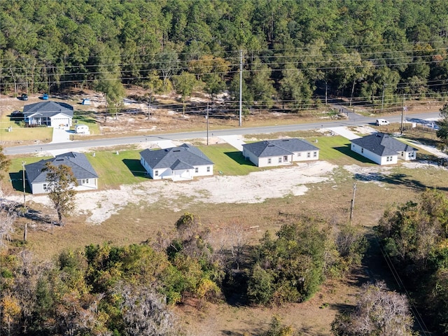 birds eye view of property with a view of trees