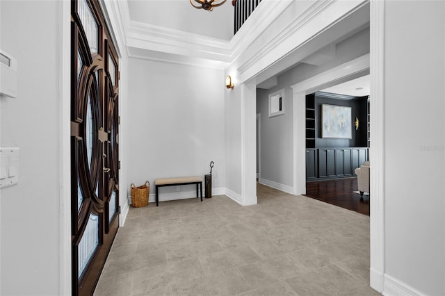 interior space with ornamental molding and baseboards